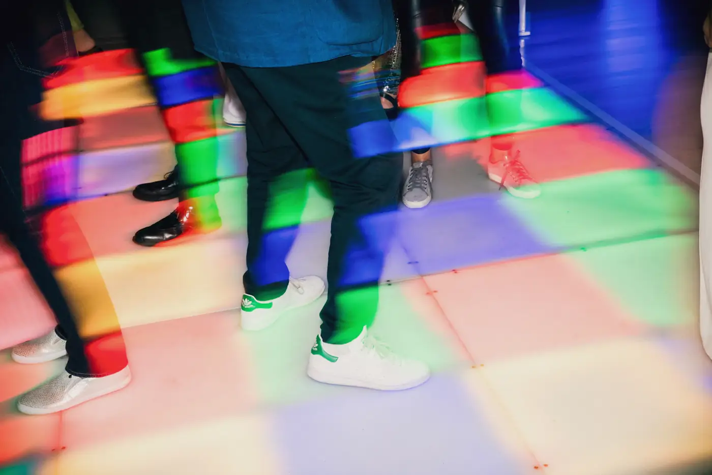 Guests dancing on a light-up dance floor