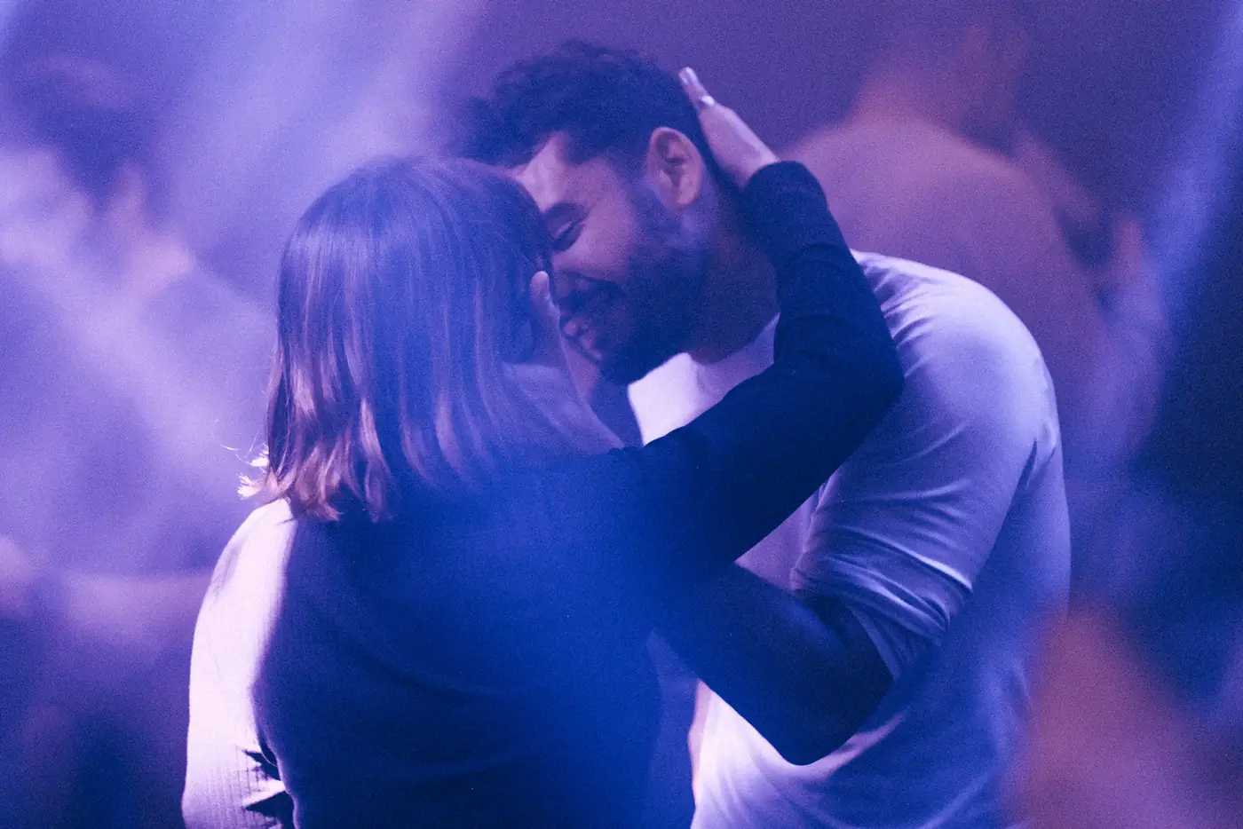 Couple dancing under violet lights