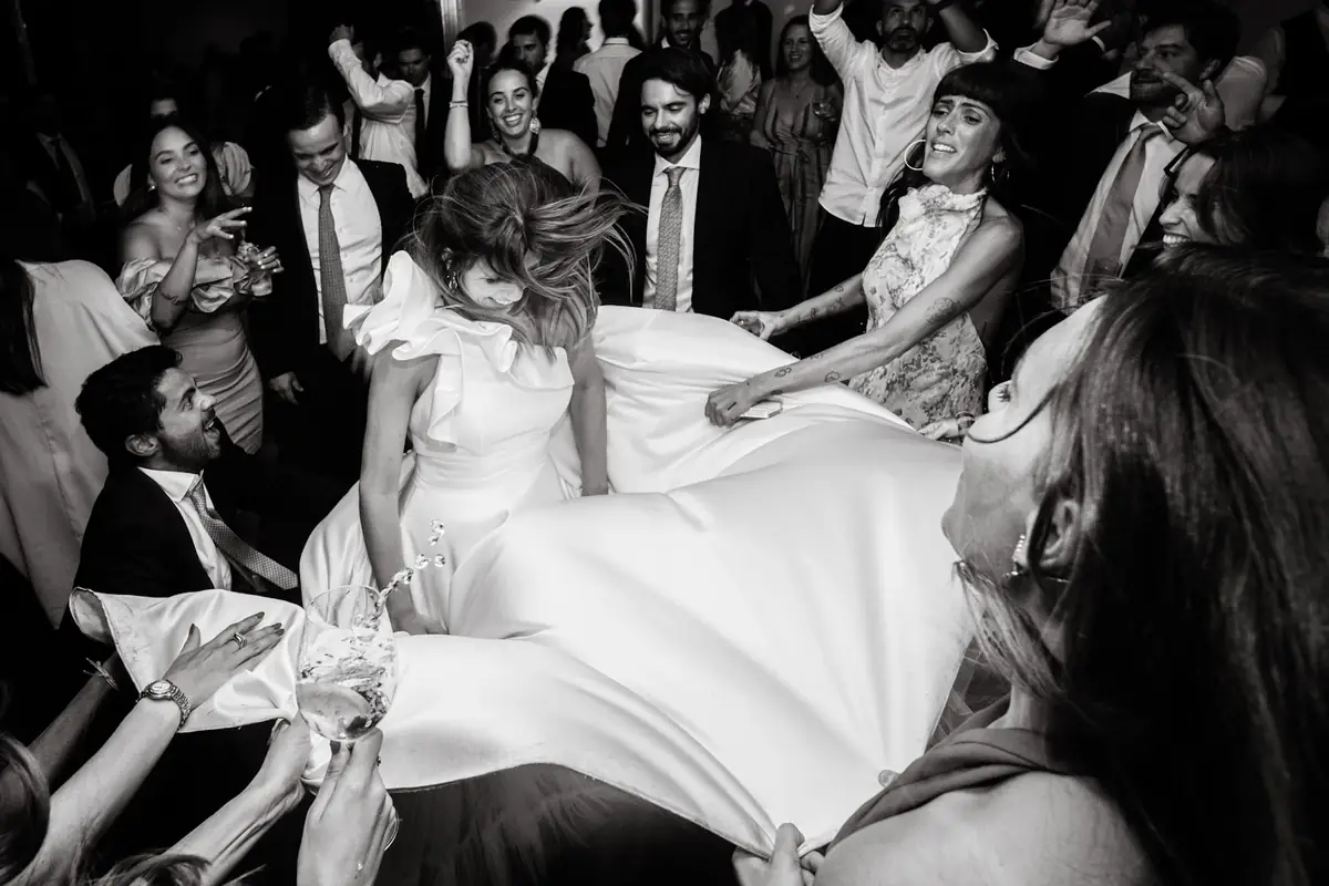 Guests lifting the bride on the dance floor